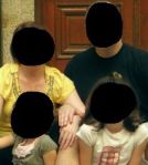 A family with the faces blacked out